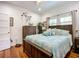 Bedroom with hardwood floors, dresser and large windows that add light to the space at 216 Murray St, New Smyrna Beach, FL 32168