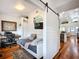 Inviting bedroom with a sliding barn door, daybed, and well-lit workspace offers flexible living at 216 Murray St, New Smyrna Beach, FL 32168
