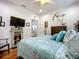 Bedroom showcasing hardwood floors, television, and decor adjacent to ensuite bathroom at 216 Murray St, New Smyrna Beach, FL 32168