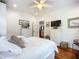 Bright bedroom with white furnishings, ceiling fan, hardwood floors, and comfortable decor at 216 Murray St, New Smyrna Beach, FL 32168