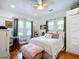Bedroom features hardwood floors, natural light, and stylish decor at 216 Murray St, New Smyrna Beach, FL 32168