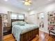Cozy bedroom with ensuite bathroom, featuring hardwood floors, and a comfortable quilt at 216 Murray St, New Smyrna Beach, FL 32168