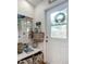 Charming entryway featuring coastal decor, storage, and a welcoming view through a windowed front door at 216 Murray St, New Smyrna Beach, FL 32168