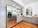 Well-equipped kitchen with stainless steel refrigerator, gray cabinets, and a farmhouse sink at 216 Murray St, New Smyrna Beach, FL 32168