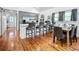 Open-concept kitchen featuring gray cabinets, a large island, stainless steel appliances, and beautiful hardwood floors at 216 Murray St, New Smyrna Beach, FL 32168