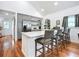 Open-concept kitchen with gray cabinets, quartz countertops, stainless steel appliances, and a breakfast bar at 216 Murray St, New Smyrna Beach, FL 32168