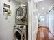 Modern laundry room with stacked washer and dryer, offering convenience and efficiency at 216 Murray St, New Smyrna Beach, FL 32168