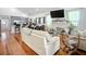 Bright living room with vaulted ceilings, hardwood floors, fireplace, and open layout to dining and kitchen at 216 Murray St, New Smyrna Beach, FL 32168