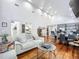 An open-concept living space with hardwood floors, white ceilings, and a comfortable seating area at 216 Murray St, New Smyrna Beach, FL 32168