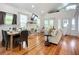 Bright living room featuring a fireplace, vaulted ceilings, hardwood floors, and comfortable seating at 216 Murray St, New Smyrna Beach, FL 32168