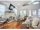This well-lit living room includes a fireplace, vaulted ceiling, hardwood floors and comfortable seating at 216 Murray St, New Smyrna Beach, FL 32168