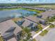 Stunning aerial view showcases the community, lake, and beautiful homes in a serene setting at 219 Venetian Palms Blvd, New Smyrna Beach, FL 32168