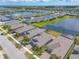 An aerial view of a residential community shows homes, ponds, manicured lawns and tree lines at 219 Venetian Palms Blvd, New Smyrna Beach, FL 32168