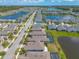 Aerial view of a residential neighborhood with well-maintained lawns, community ponds, and tree lines at 219 Venetian Palms Blvd, New Smyrna Beach, FL 32168