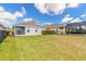 Expansive backyard with lush green grass, perfect for outdoor activities and entertaining guests at 219 Venetian Palms Blvd, New Smyrna Beach, FL 32168