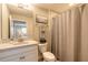 Cozy bathroom featuring a shower, vanity with solid surface countertop, and decorative artwork at 219 Venetian Palms Blvd, New Smyrna Beach, FL 32168