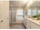 Bright bathroom featuring wood-look tile, large tub, glass shower and double vanity with granite counters at 219 Venetian Palms Blvd, New Smyrna Beach, FL 32168