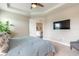 Comfortable bedroom with ceiling fan, flat screen TV and entry to another room with a glimpse of the living room at 219 Venetian Palms Blvd, New Smyrna Beach, FL 32168