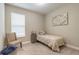 Bright bedroom with a twin bed, chair, and artwork creating a peaceful and inviting space at 219 Venetian Palms Blvd, New Smyrna Beach, FL 32168