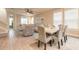 Open-concept dining room featuring hardwood floors, neutral paint, and a view of the living area and back yard at 219 Venetian Palms Blvd, New Smyrna Beach, FL 32168