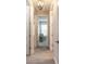 Hallway with wood-look tile flooring offering open access to rooms with natural light and neutral tones at 219 Venetian Palms Blvd, New Smyrna Beach, FL 32168