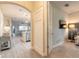 Hallway with wood-look tile flooring leading to the living area and bedroom at 219 Venetian Palms Blvd, New Smyrna Beach, FL 32168