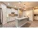 Bright kitchen with stainless steel appliances, a large center island with a sink, and plenty of cabinet space at 219 Venetian Palms Blvd, New Smyrna Beach, FL 32168