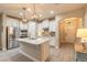 Open kitchen with stainless steel appliances, granite countertops, a center island with a sink, and pendant lighting at 219 Venetian Palms Blvd, New Smyrna Beach, FL 32168