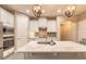 Well-lit kitchen featuring stainless steel appliances, a large island with quartz countertop and stylish pendant lights at 219 Venetian Palms Blvd, New Smyrna Beach, FL 32168