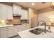 Bright kitchen showcasing stainless steel appliances, a granite island with a sink, and custom cabinetry at 219 Venetian Palms Blvd, New Smyrna Beach, FL 32168