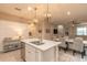 Bright open-concept kitchen and dining area with stainless steel appliances, hardwood floors, and neutral colors at 219 Venetian Palms Blvd, New Smyrna Beach, FL 32168