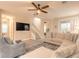 Inviting living room featuring tile floors, a comfortable sofa, and a staircase at 219 Venetian Palms Blvd, New Smyrna Beach, FL 32168