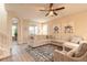 Open-concept living room with tile floors, neutral decor, and ample seating at 219 Venetian Palms Blvd, New Smyrna Beach, FL 32168