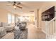 Bright, open-concept living room seamlessly flows into the kitchen and features stylish furnishings and decor at 219 Venetian Palms Blvd, New Smyrna Beach, FL 32168