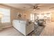 Bright living room with tile flooring, neutral colors, and a view into the dining area at 219 Venetian Palms Blvd, New Smyrna Beach, FL 32168