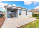Covered patio with outdoor seating provides a relaxing space for dining and enjoying the backyard at 219 Venetian Palms Blvd, New Smyrna Beach, FL 32168