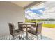 A charming patio with a table and chairs overlooking a tranquil lake offers a relaxing outdoor space at 219 Venetian Palms Blvd, New Smyrna Beach, FL 32168