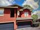 Red stucco townhouse with attached two-car garage at 240 Villa Di Este Ter # 212, Lake Mary, FL 32746
