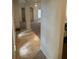 A view down a hallway with tile floors that leads to a carpeted living room at 240 Villa Di Este Ter # 212, Lake Mary, FL 32746