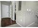 Hallway with dark wood floors and white walls leads to other rooms of the house at 240 Villa Di Este Ter # 212, Lake Mary, FL 32746