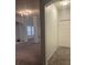 An open living room with high ceilings, plush carpet, and large support beams at 240 Villa Di Este Ter # 212, Lake Mary, FL 32746