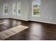 Living room with plenty of natural light and dark hardwood floors at 240 Villa Di Este Ter # 212, Lake Mary, FL 32746