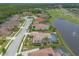 Lovely homes near a golf course and pond, featuring tile roofs, screened pools, and mature trees at 254 Cappella Ct, New Smyrna Beach, FL 32168
