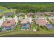 Stunning aerial view of beautiful homes, featuring a screened pool and lush landscaping near a green golf course at 254 Cappella Ct, New Smyrna Beach, FL 32168