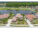 Beautiful aerial view of home with lake view, screened in pool and well-manicured lawns at 254 Cappella Ct, New Smyrna Beach, FL 32168