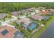 Beautiful homes with tile roofs, palm trees, and screened pools on a well-manicured street at 254 Cappella Ct, New Smyrna Beach, FL 32168
