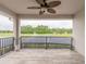 Outdoor balcony overlooking the tennis courts, lake, and luscious trees at 254 Cappella Ct, New Smyrna Beach, FL 32168