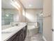 Modern bathroom with a double vanity, a soaking tub, and a glass-enclosed shower at 254 Cappella Ct, New Smyrna Beach, FL 32168