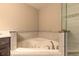 Elegant bathroom with a soaking tub, tiled surround, and glass-enclosed shower at 254 Cappella Ct, New Smyrna Beach, FL 32168