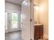 Stylish half-bath featuring modern vanity and fixtures, next to the front door with decorative glass at 254 Cappella Ct, New Smyrna Beach, FL 32168